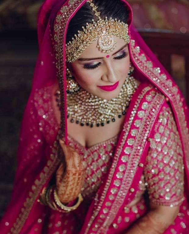 Image of Young Indian female wearing ethnic pink dress with jewelry and  bridal makeup-GP568152-Picxy